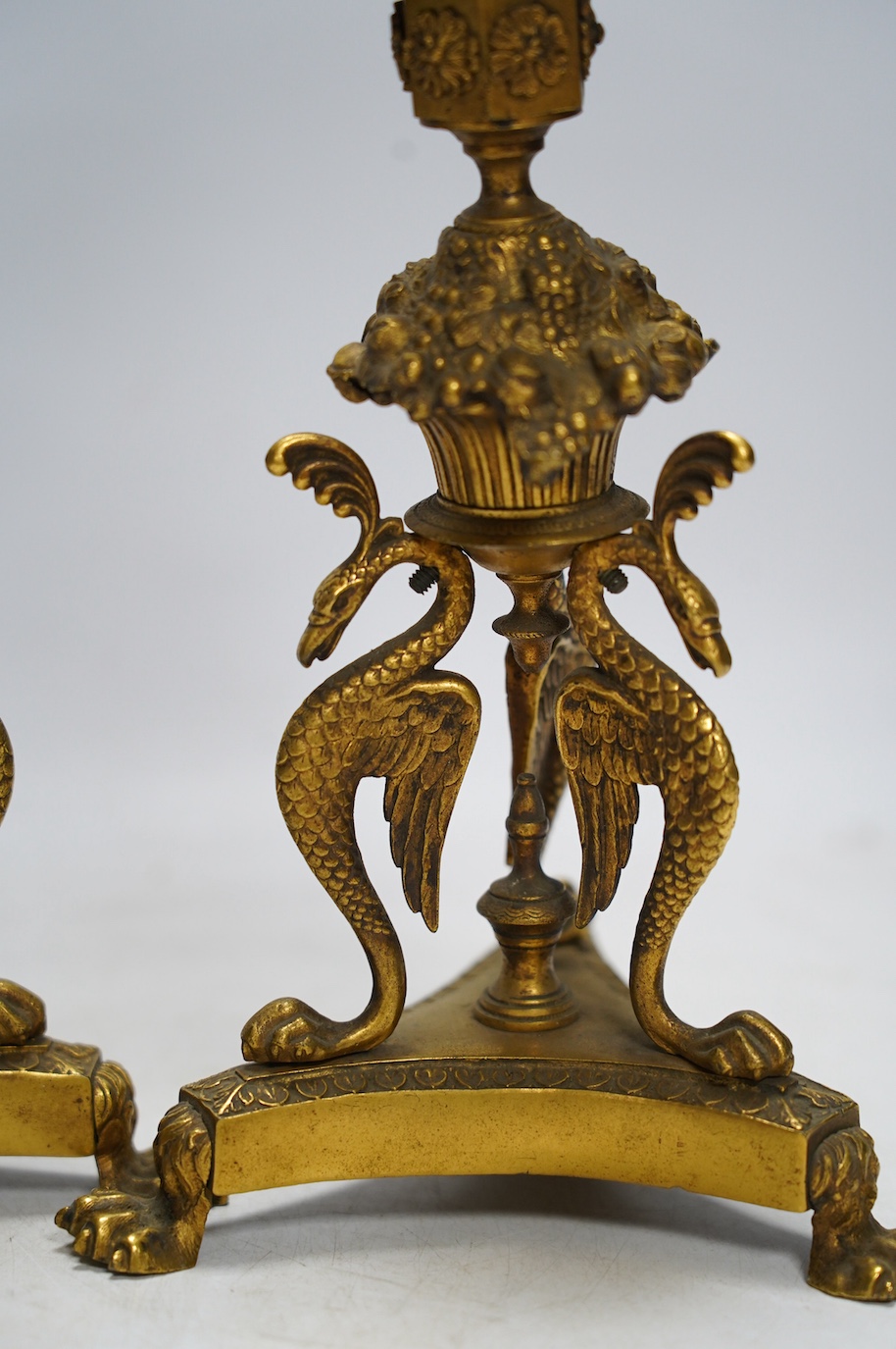 A pair of Empire style ormolu candlesticks, 20cm. Condition - fair to good